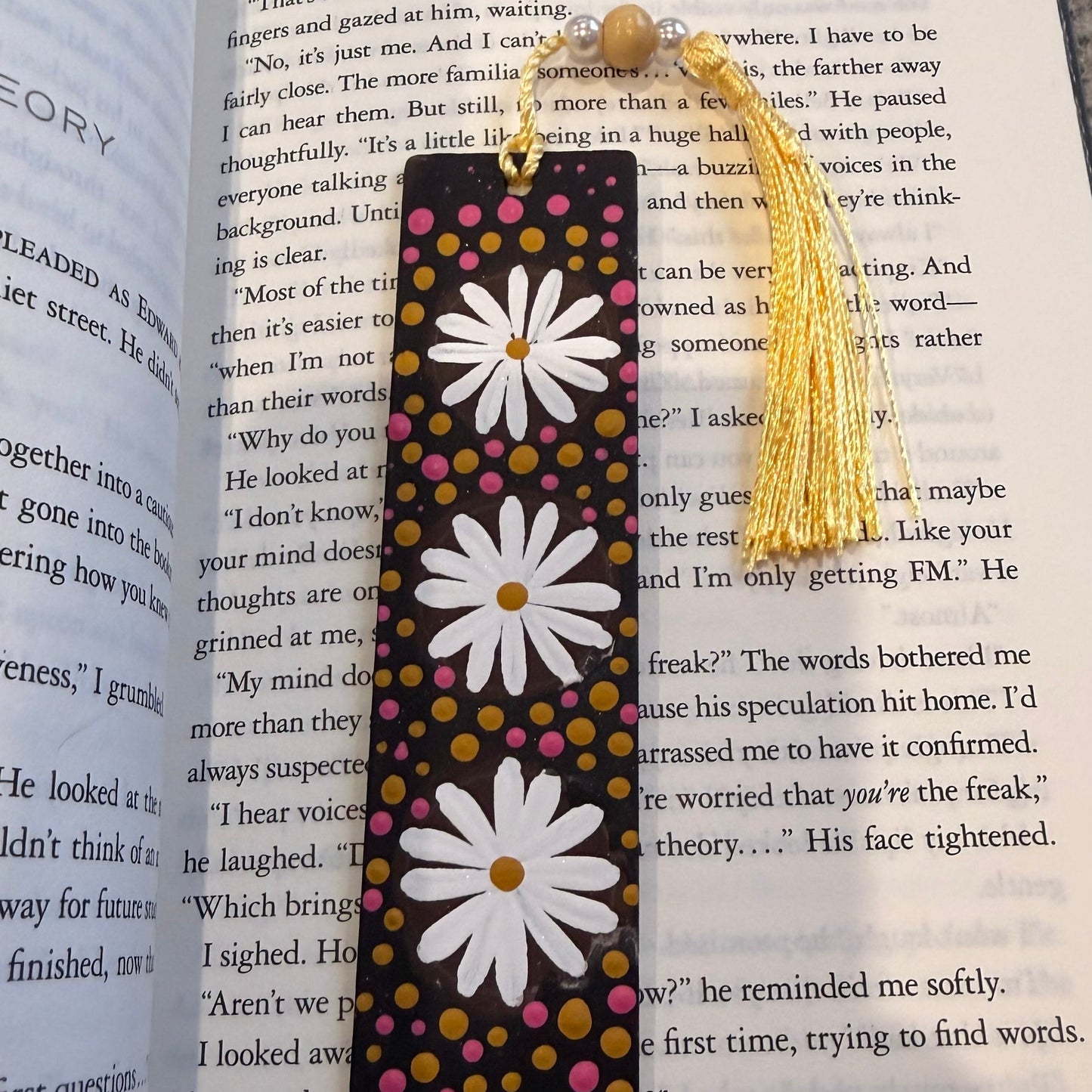 Bookmark with daisy design on an open book