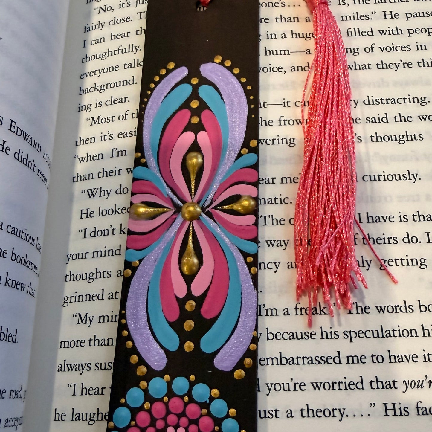 Decorative bookmark with colorful design and tassel on an open book