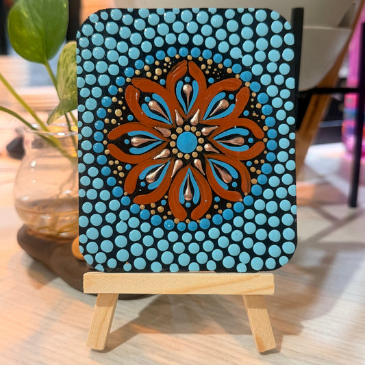 Decorative piece with a blue and brown pattern mini mandala art on a wooden stand.