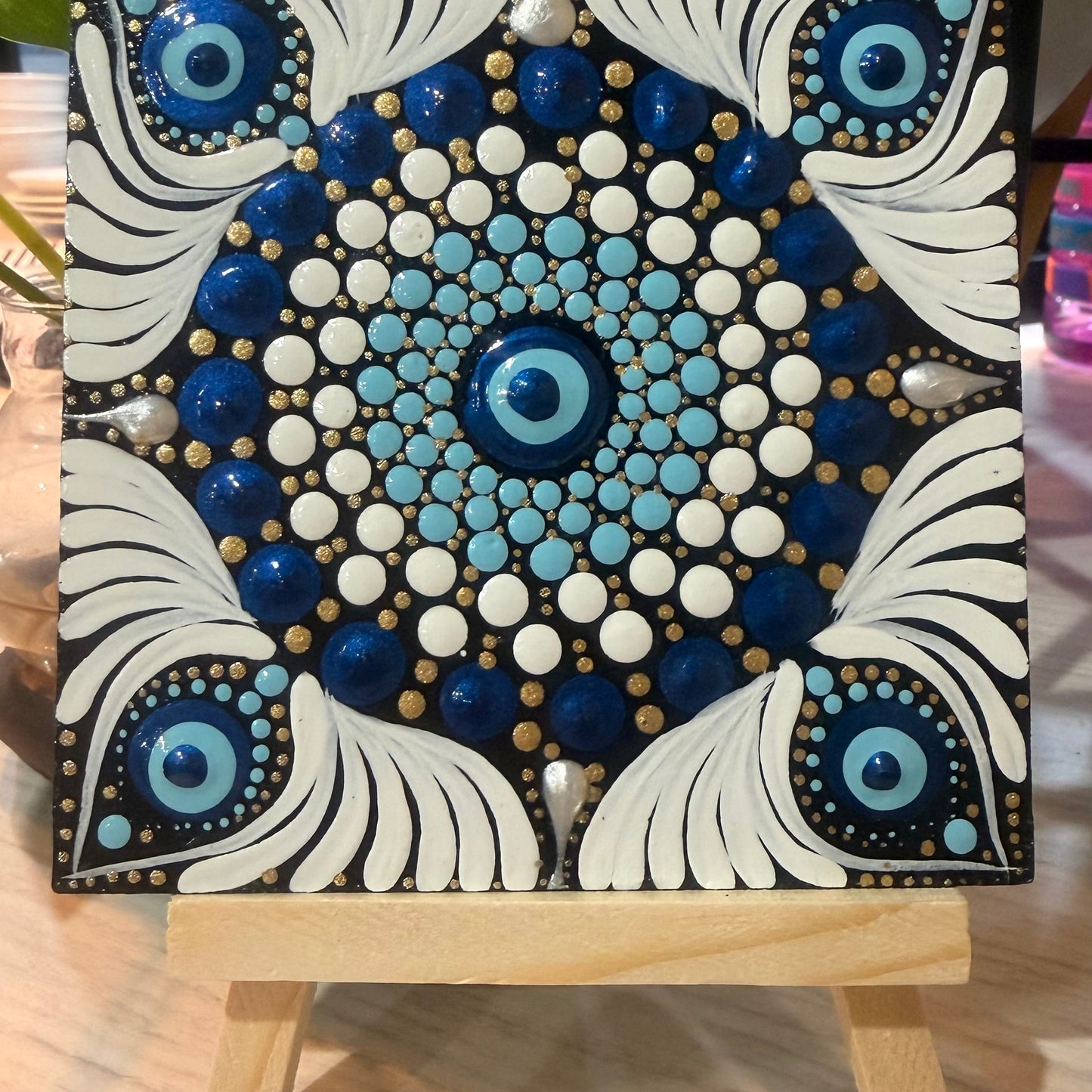 Decorative painting with blue, white, and black patterns on a small easel can be used as a table top mini mandala or fridge magnet (back of the painting covered with magnetic tape)