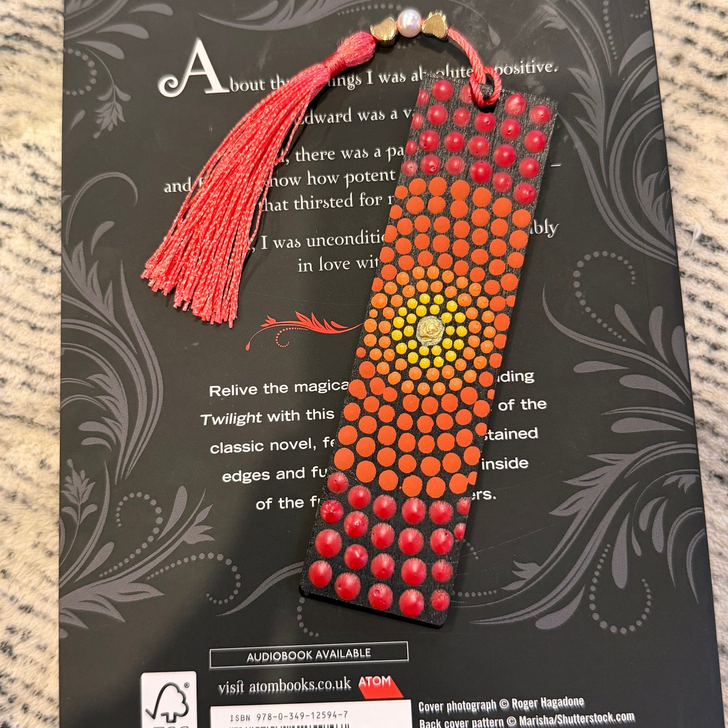 Mandala wooden bookmark with beads and tassel on a book