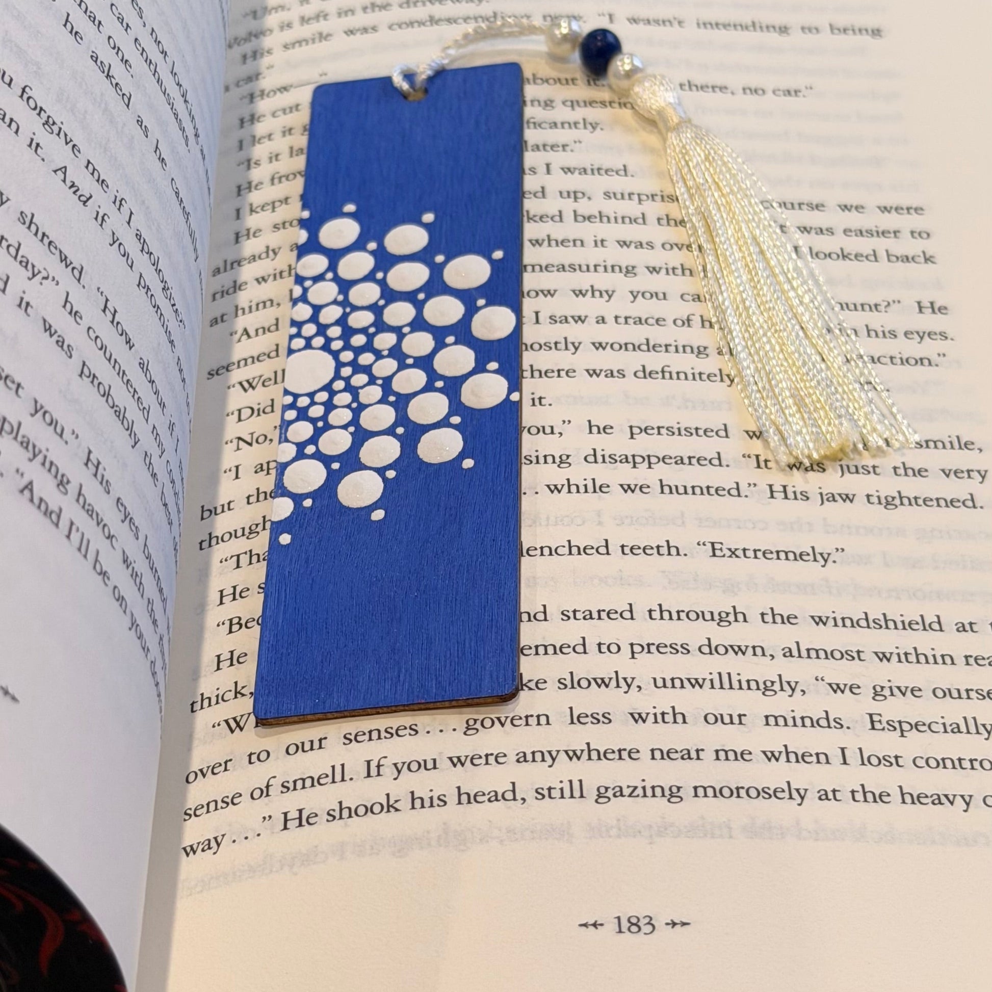 Crafts bucket Blue and white geometric wooden bookmark on an open book