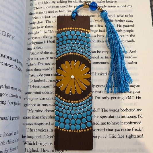 Decorative bookmark with blue tassel on an open book