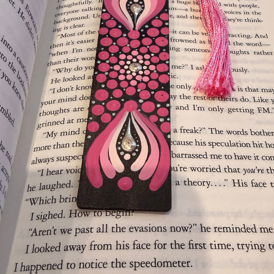 Pink and black floral bookmark on an open book