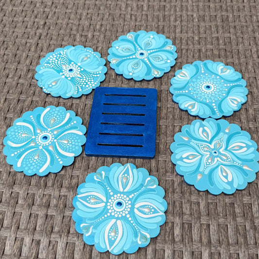 Set of blue decorative coasters with a central blue vent on a textured surface.