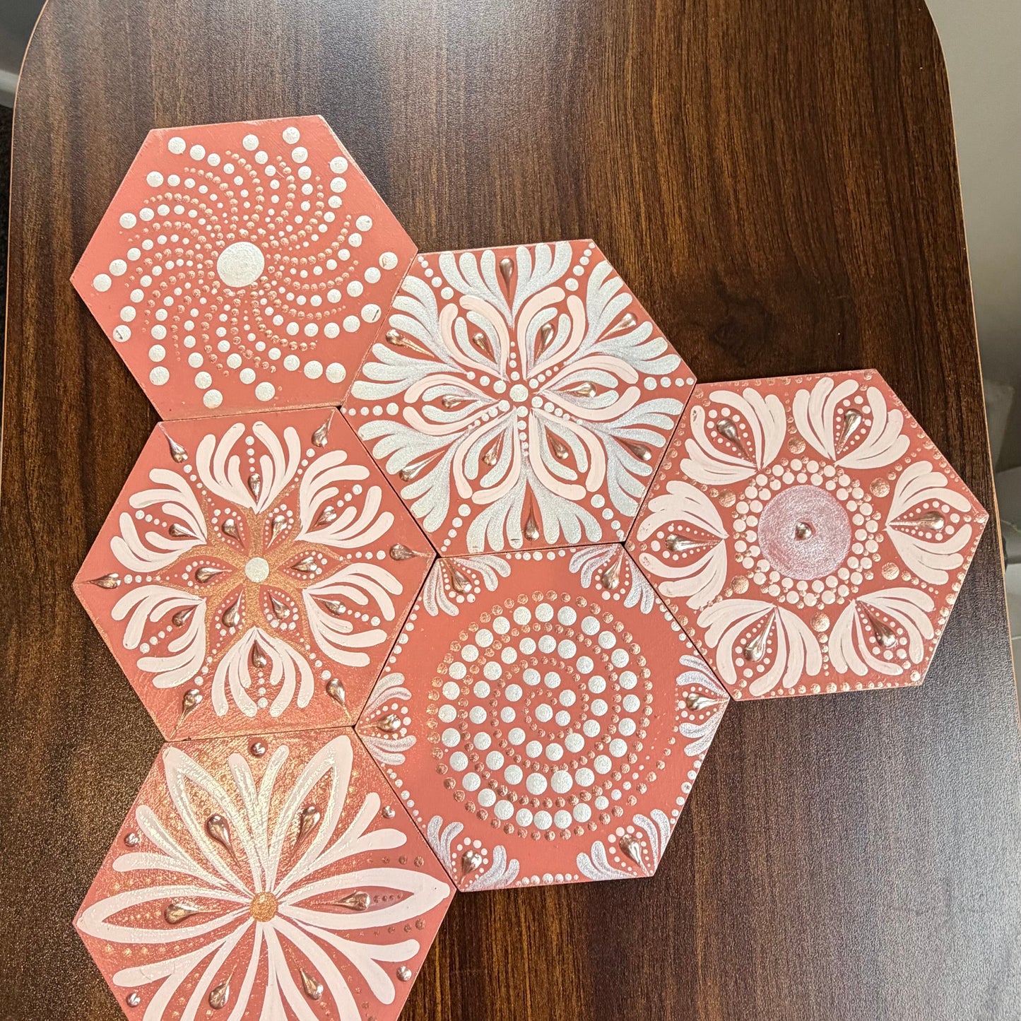 Hexagonal patterned coasters on a wooden surface