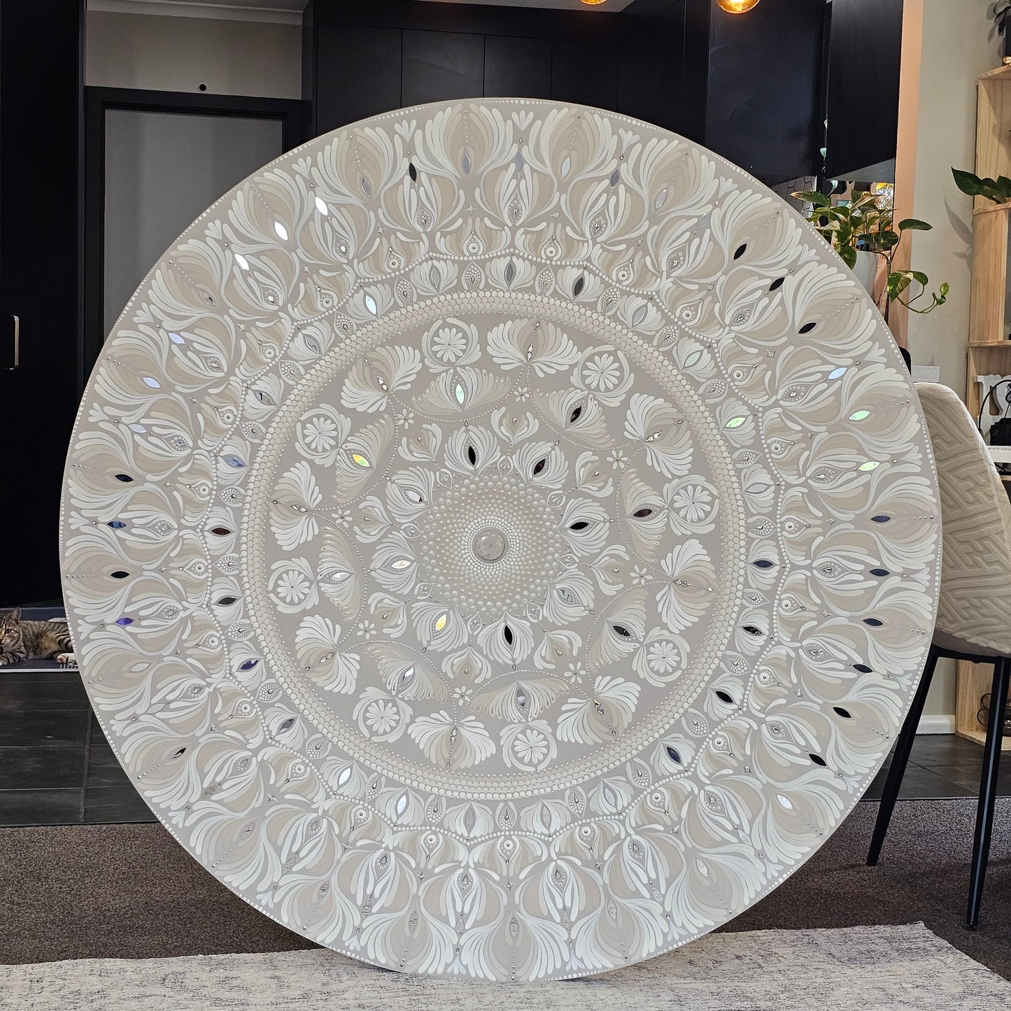 Decorative round rug with intricate patterns on a floor.